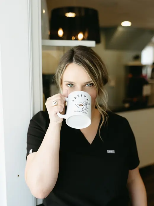 Marley with a coffee mug in the clinic