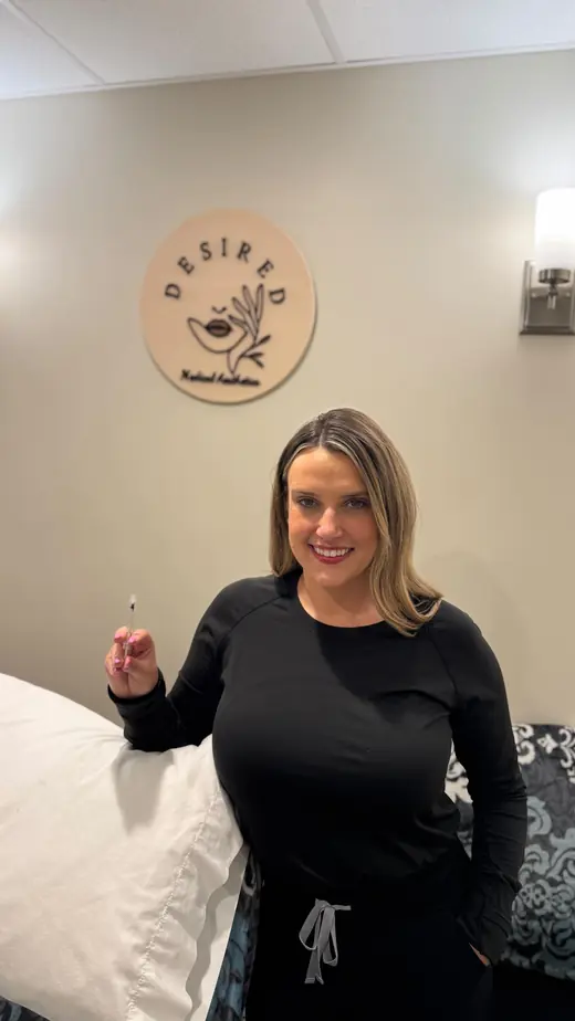 Marley standing in the treatment room beside the sign