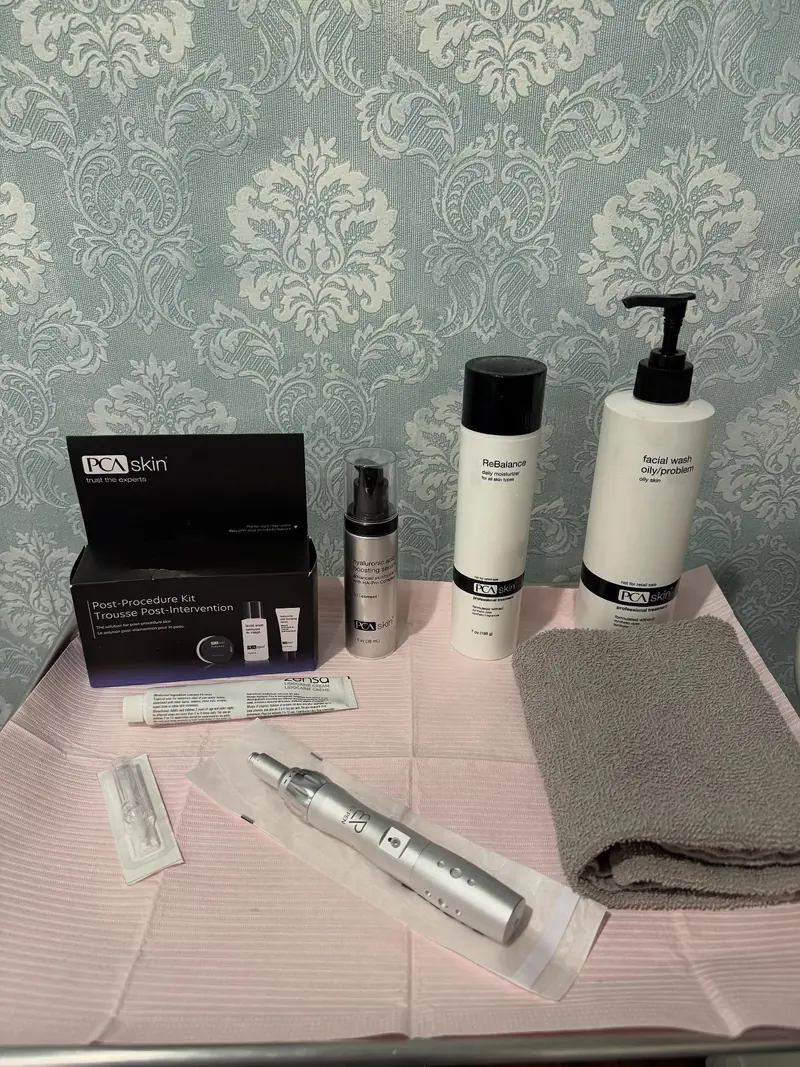 Microneedling pen and skin care products laid out on a tray