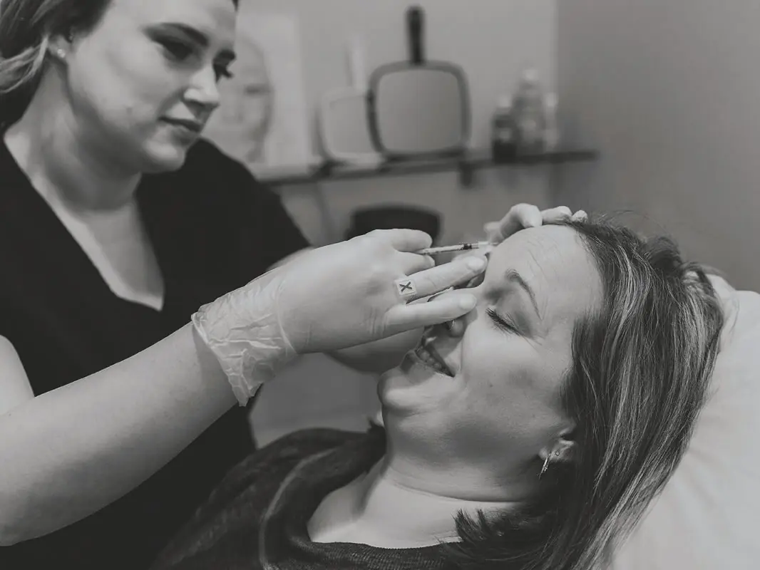 Injector giving a neurotoxin treatment, black and white