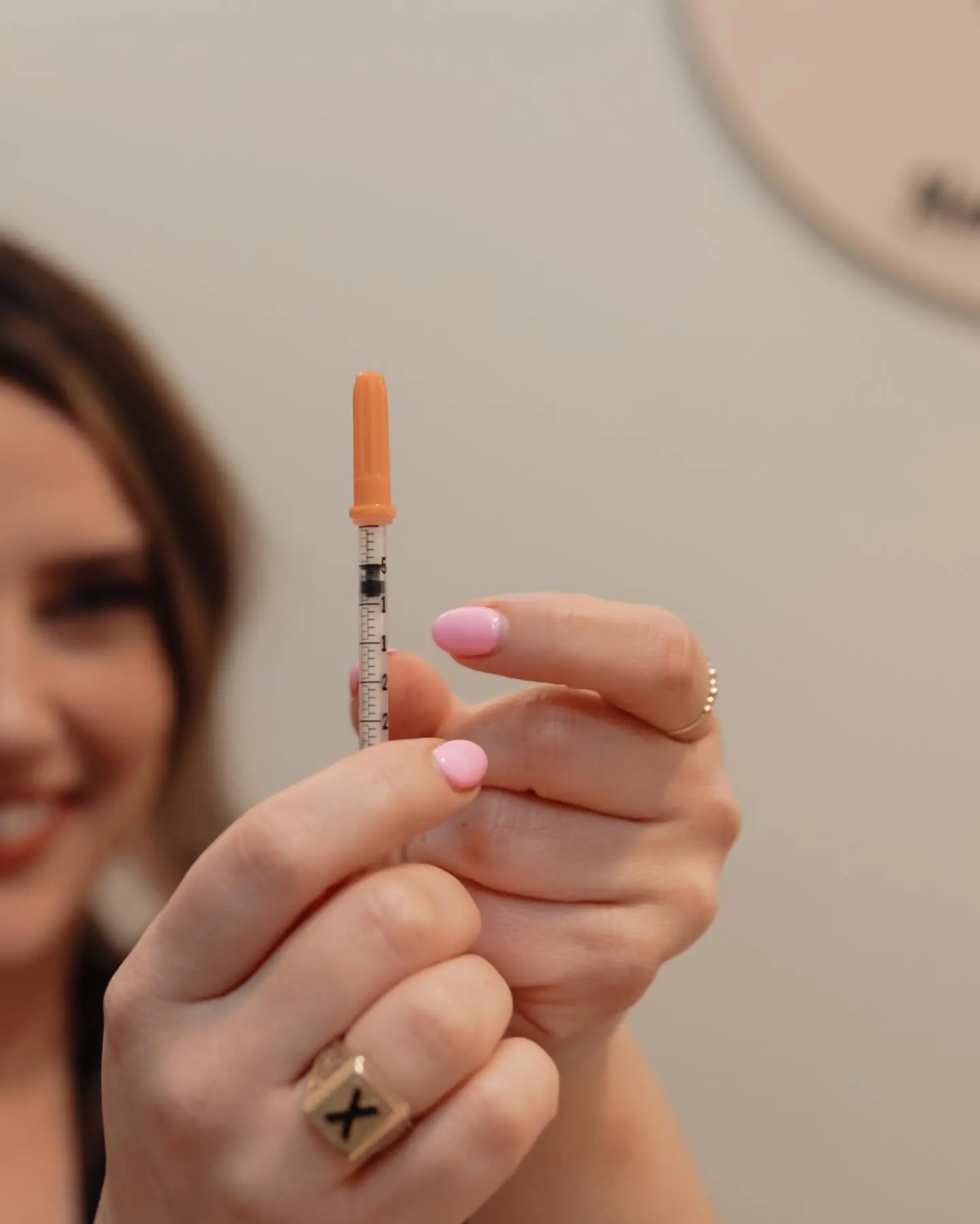 Close view of a syringe held in warm light