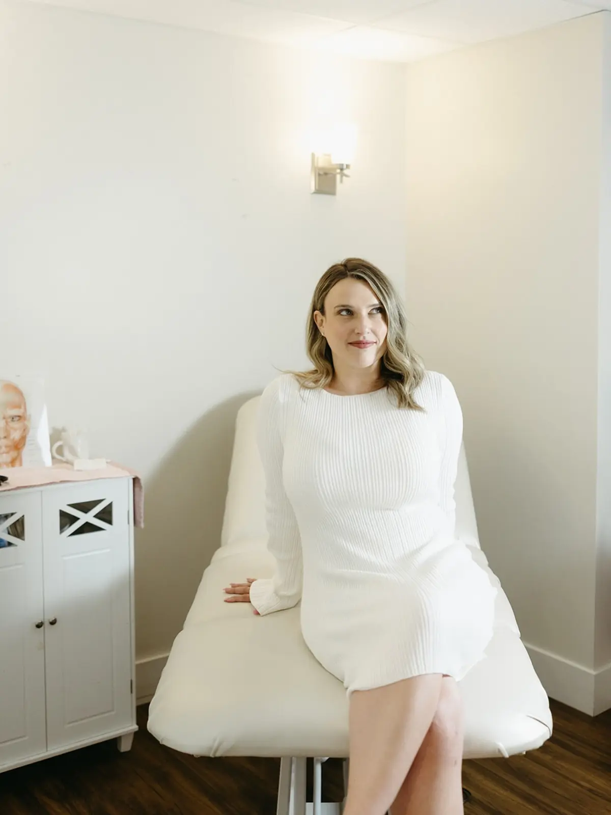 Marley in a white dress seated on the treatment chair