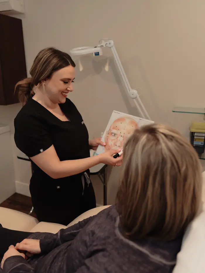 Marley working with a client beside a face chart
