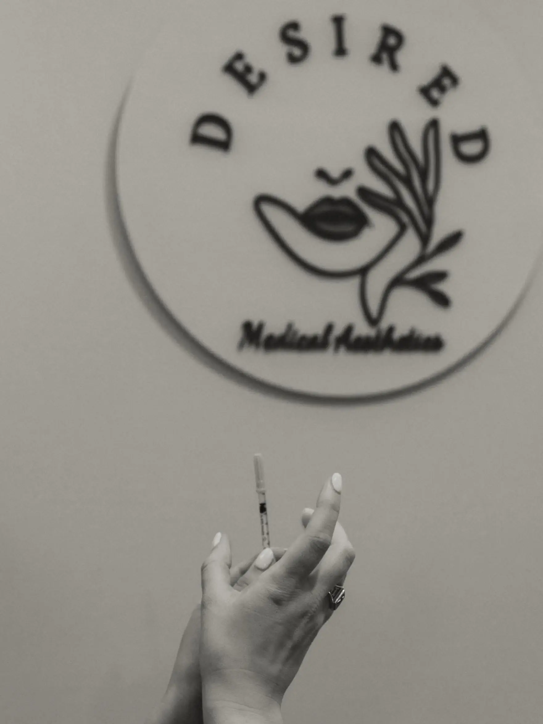 Clinic wall sign with a hand holding a syringe